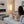 Laden Sie das Bild in den Galerie-Viewer, Eine Frau sitzt mit wärmenden Kuschelsocken in ihrem Wohnzimmer auf der Couch und schaut in den Kamin. Die warmen Socken haben einen Plüschrand und werden als wärmende Hausschuhe getragen.