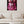 Laden Sie das Bild in den Galerie-Viewer, An einer beigen Wand hängt ein Glasbild von einem Pudel in der Farbe Pink. Er trägt einen pinken Anzug und eine rosa Sonnenbrille. Der Pudel sitzt auf einem Sesel vor einem dunklen Vorhang.