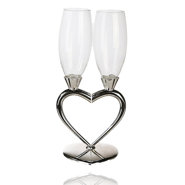 Diese wunderschönen Champagnergläser aus Glas sind mit einem silberfarbenen Metallstiel in Herzform versehen, der entsteht, wenn beide Gläser zusammenkommen.