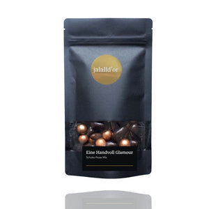 Auf einer schwrzen Tüte steht die aufschrift Jalalld`or und eine Handvoll Glamour. Schoko Nuss Mix.