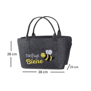 Ein dunkelgrauer Shopper auf weißem Hintergrund. Auf dem Filzshopper steht "Fleißige Biene" Daneben ist eine schwarz gelbe Biene eingestickt.