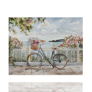 Im Vordergrund steht ein Fahrrad mit Blumenkord an einem Geländer gelehnt. Im Hintergrund ist das Meer und eine Küstenlandschaft. Es sieht nach einer idyllischen Pause aus.