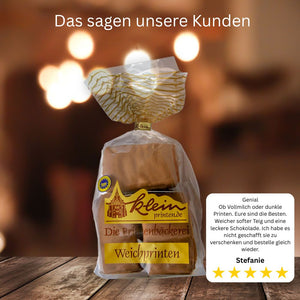 Nahaufnahme Aachener Printen, mit Vollmilchschokolade überzogen, neben einer kurzen Produktrezension dargestellt