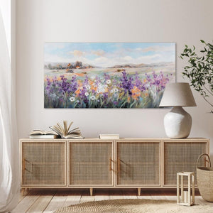 Ein großes Landschaftsgemälde der Provance oder der Toskana hängt über einem Sideboard an der Wand.