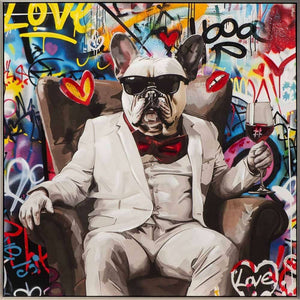 Humorvolles Tierporträt einer Bulldogge im eleganten weißen Anzug, die mit Sonnenbrille und Weinglas in einem Sessel vor einer bunten Street-Art-Wand posiert.